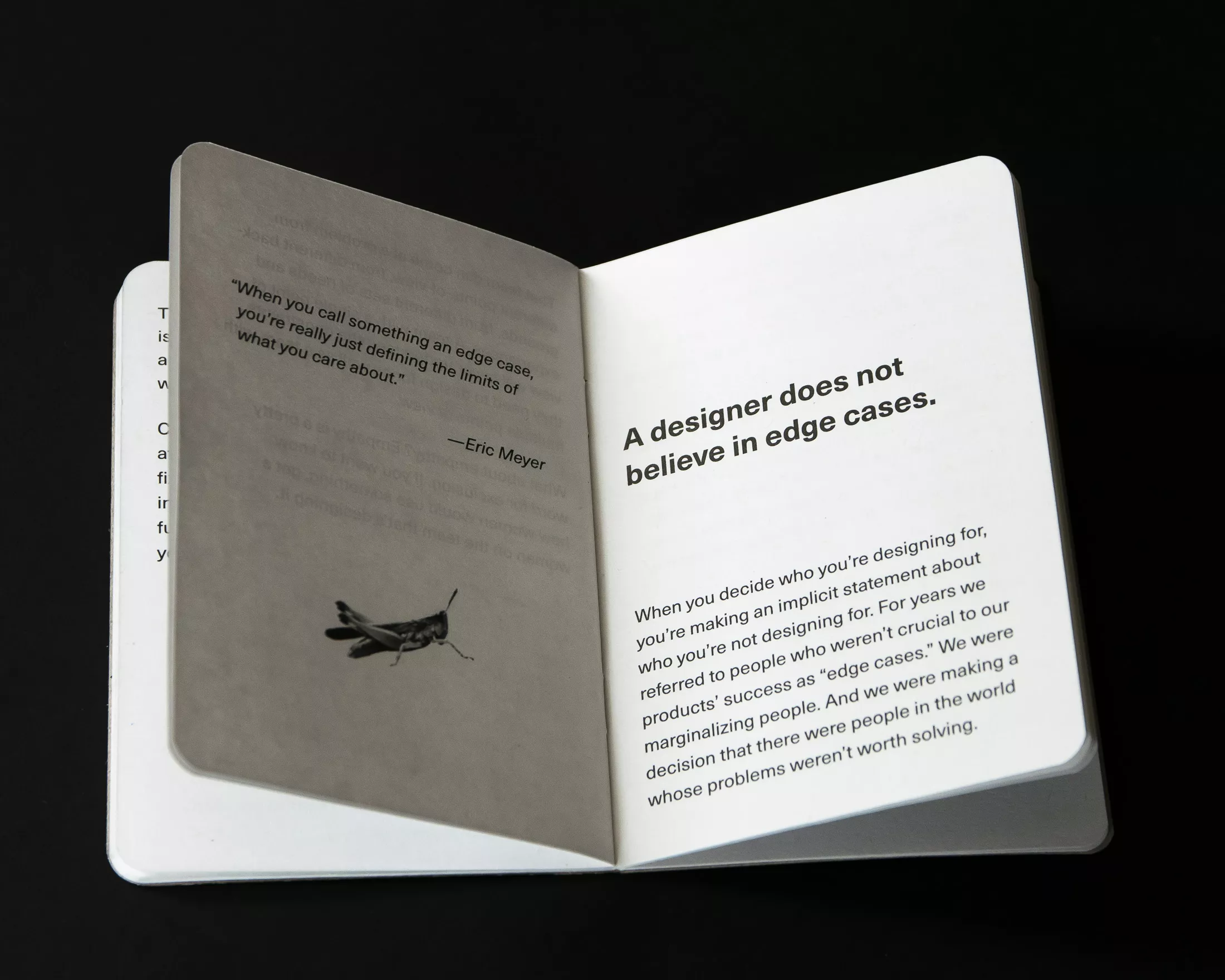 Inside pages of a booklet with a quote from Eric Meyer on the left and bold text on the right reading “A designer does not believe in edge cases.”